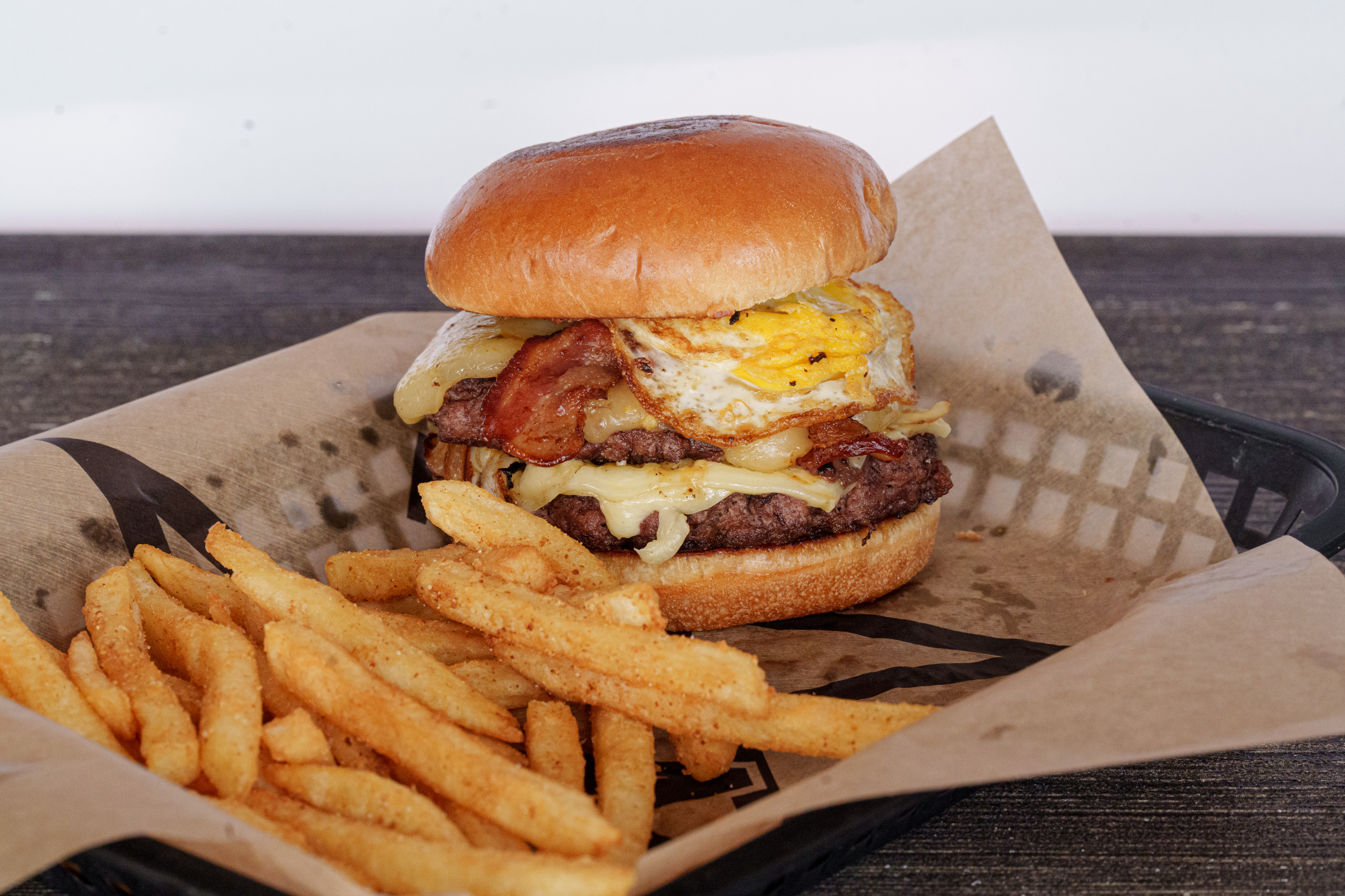 Purple Frog signature burger with egg, bacon, and fries