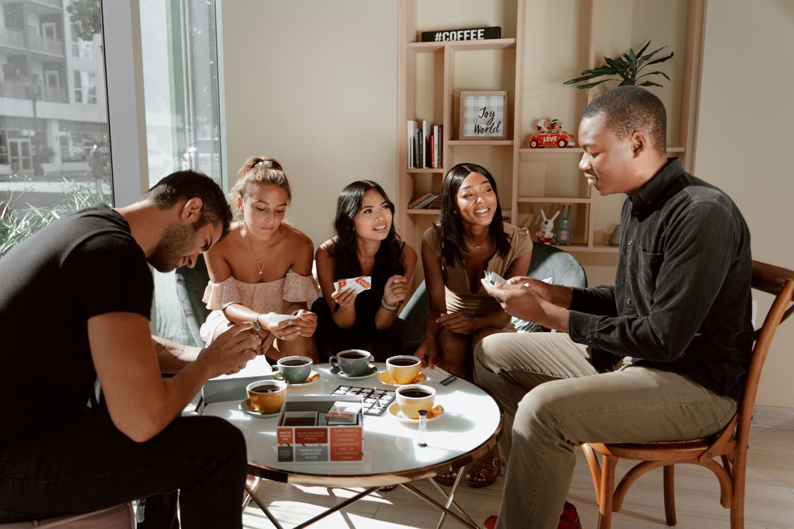 Event inspiration: friends playing cards together in a sunny café